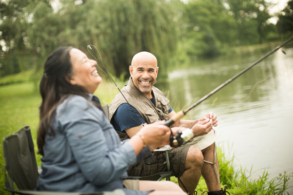 Man and woman fishing in a pond